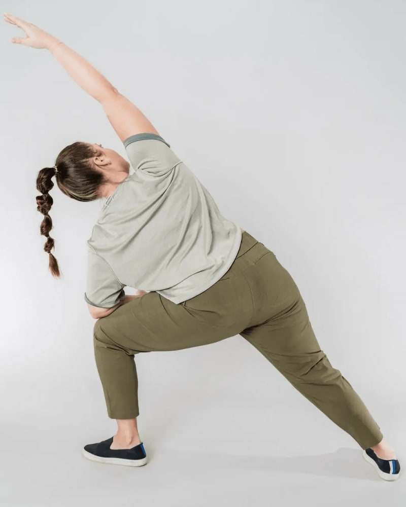 Back of a model wearing a size 3X open air pant (28") in olive by alder apparel. | dia_product_style_image_id:300618